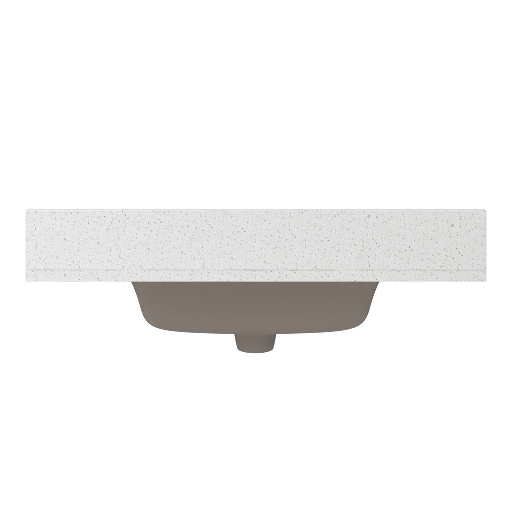 Front view of a speckled stone vanity countertop with a centered undermount ceramic sink in stone color visible beneath, showing the rectangular top edge and curved basin from below.