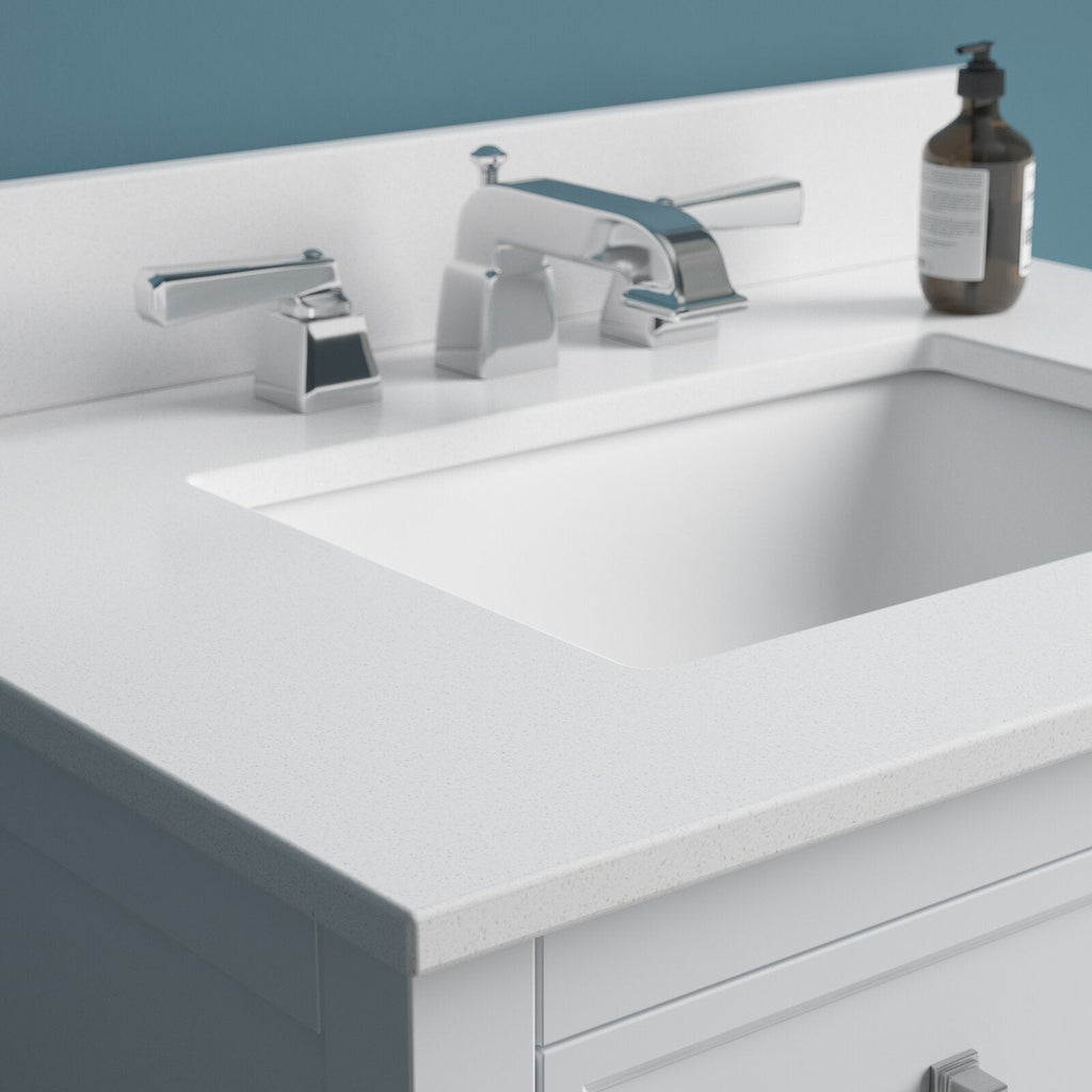 Close-up of a modern solid-wood bathroom vanity in a stone finish showing a stone-colored countertop with a rectangular undermount sink, chrome widespread faucet and a soap dispenser on the deck.