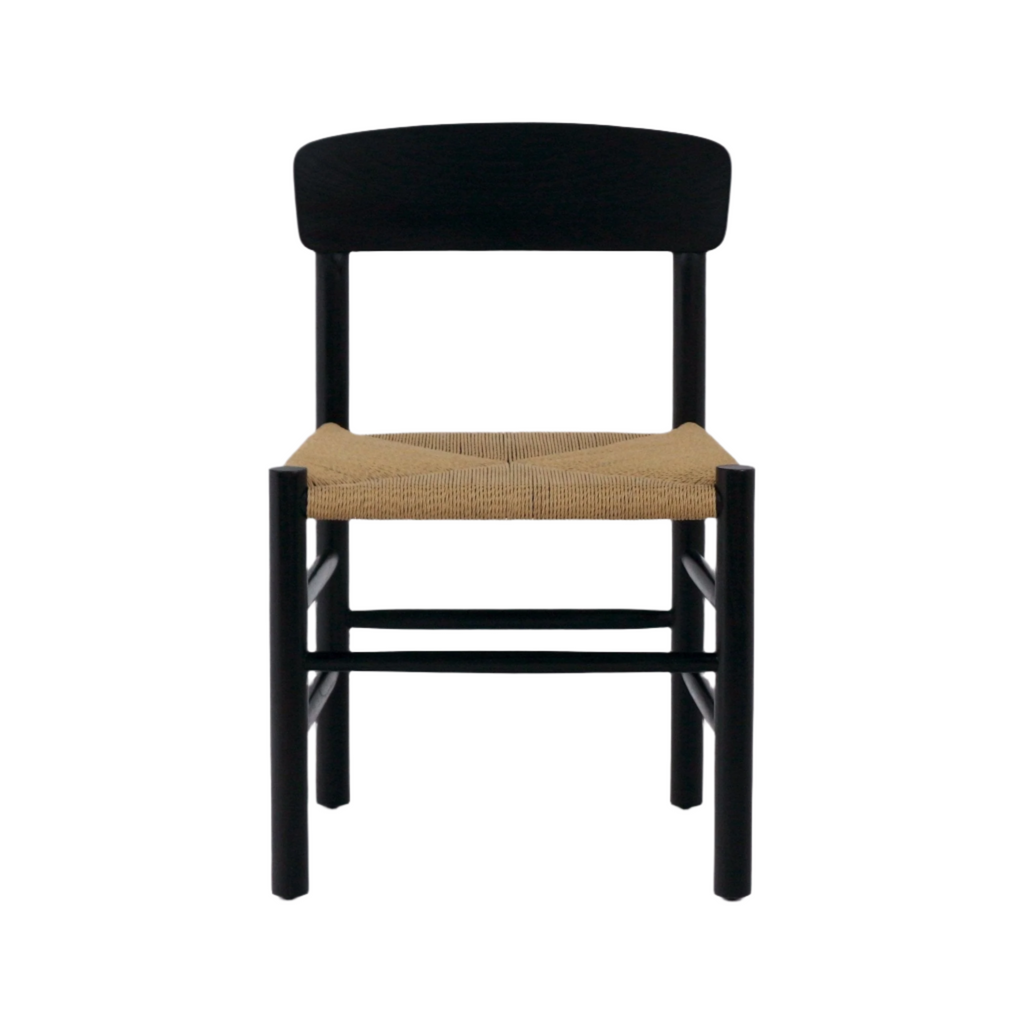 Front-facing mid-century modern Danish dining chair with a black solid wood (mahogany) frame, curved backrest and a natural woven papercord seat.