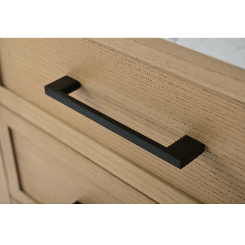 Close-up of a matte black bar drawer handle mounted on a light stone-colored solid wood vanity drawer front, highlighting the wood grain and modern rectangular pull.