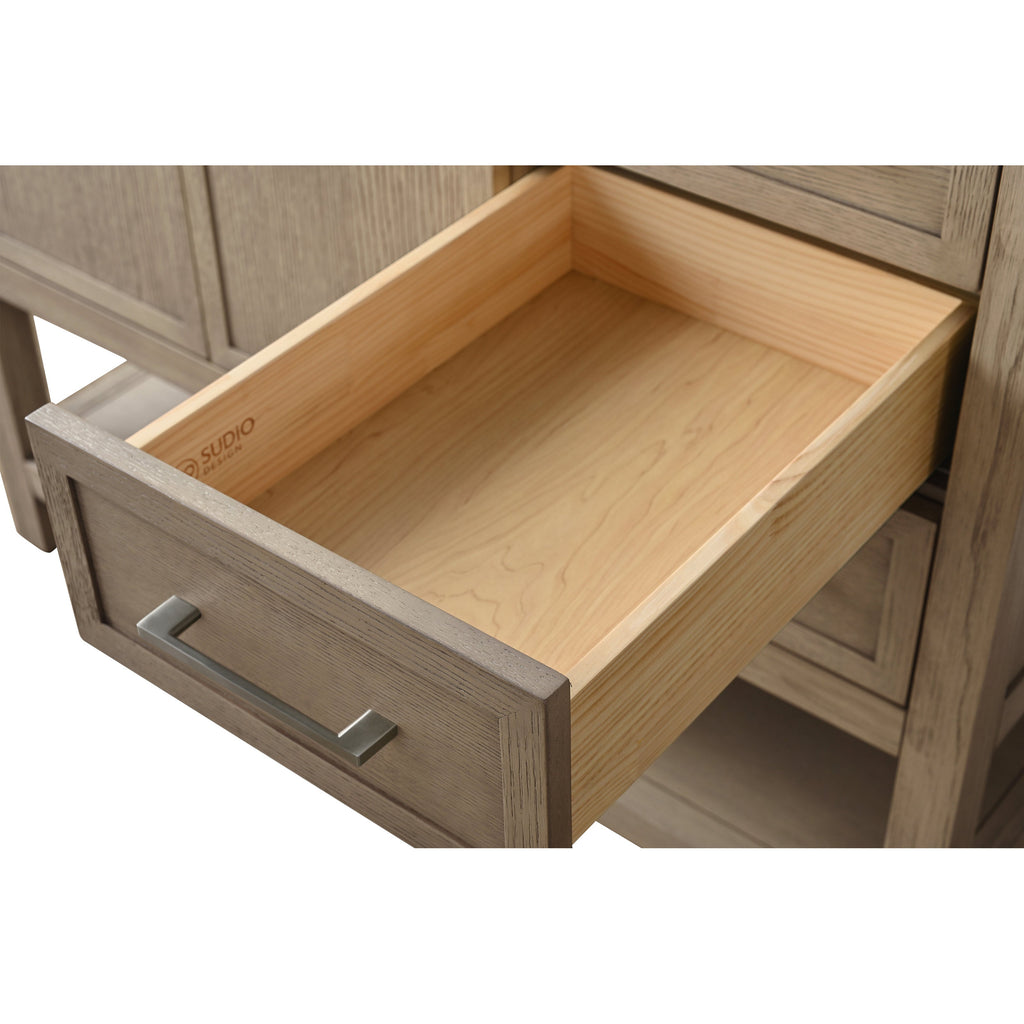 Close-up of an open bathroom vanity drawer showing a light solid-wood interior and grey-stained wooden front with a rectangular brushed-metal pull, highlighting the wood grain and clean joinery.