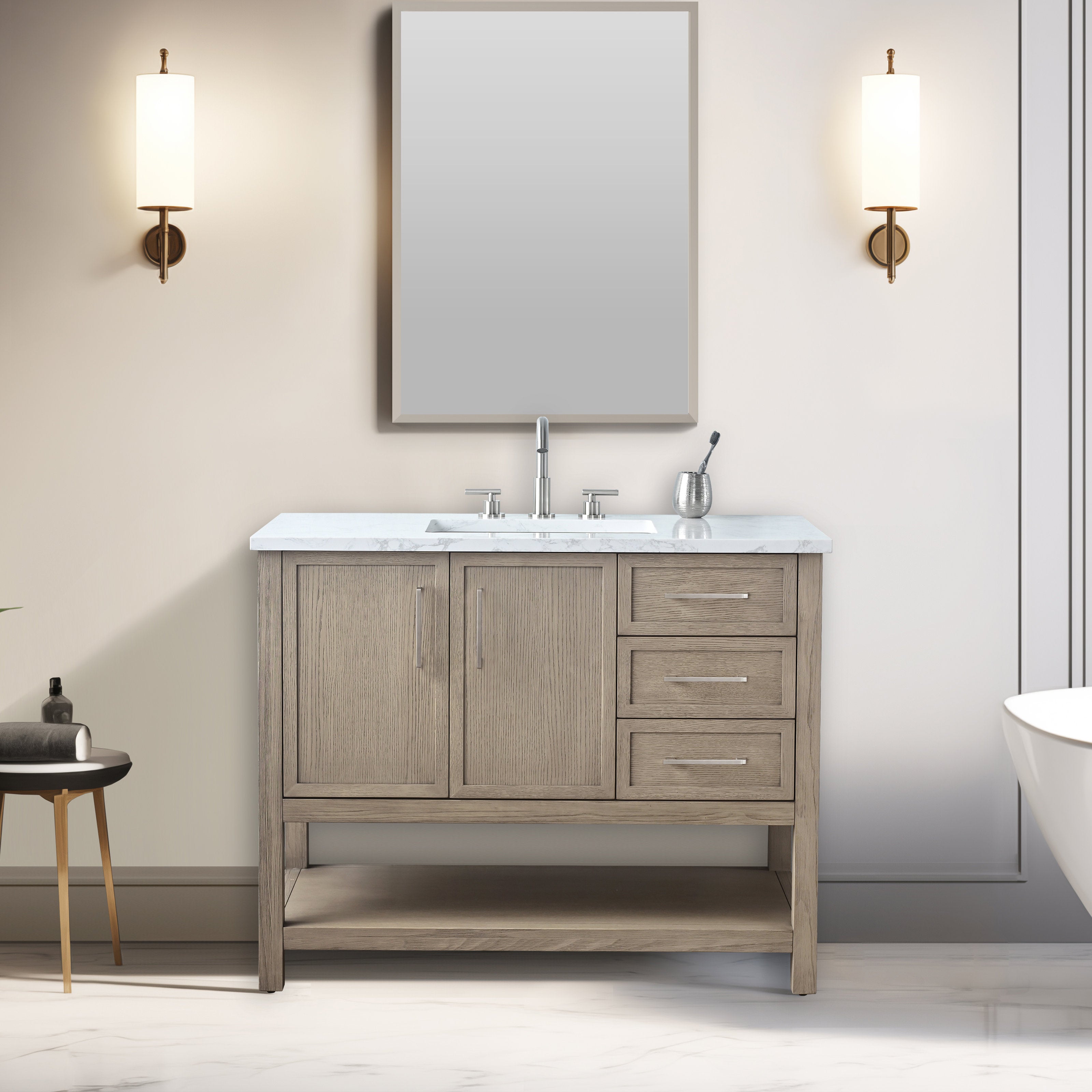 Modern 42-inch single-sink solid wood bathroom vanity in stone finish with marble top, undermount ceramic sink, chrome faucet, three right-side drawers, two cabinet doors, open lower shelf, and brass wall sconces beside a mirror.