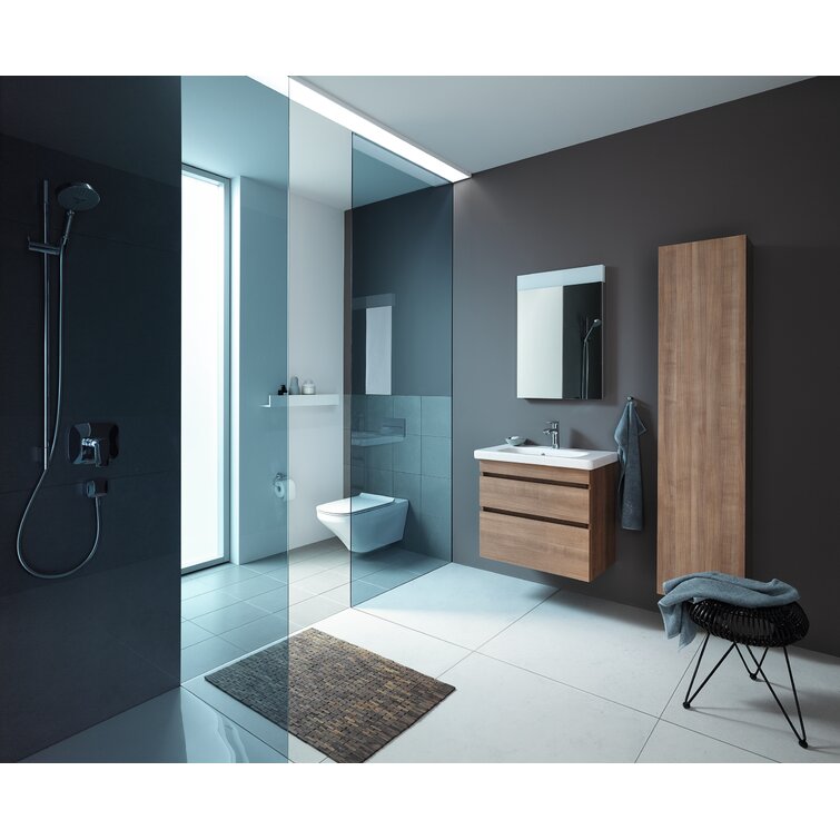 Modern bathroom with a wall-mounted single-sink solid wood vanity topped with a stone countertop and white ceramic basin, matching tall wood cabinet and mirror, glass shower partition, wall-hung toilet and gray tile floor.