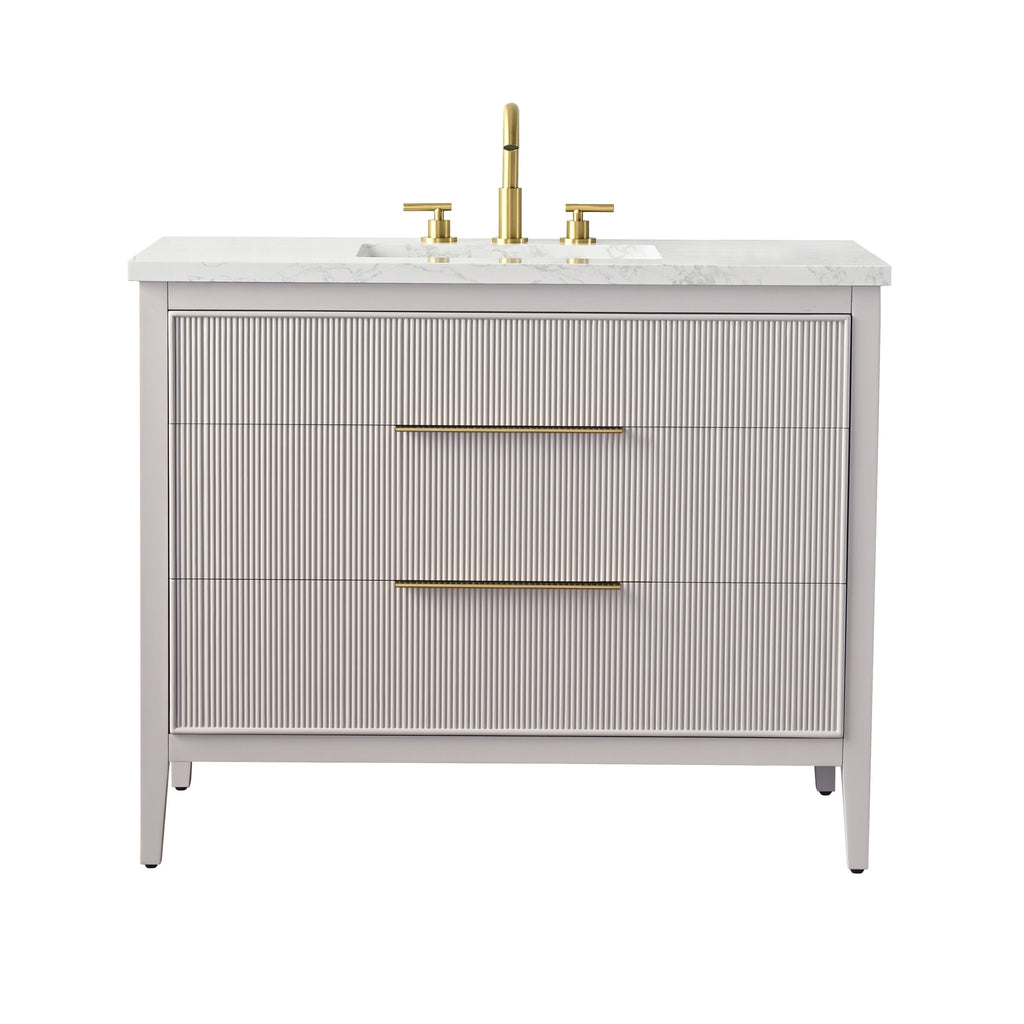 42-inch modern freestanding single-sink bathroom vanity with a stone-look marble top, undermount rectangular ceramic sink, solid wood fluted taupe cabinet with two wide drawers and long brushed brass handles and faucet.