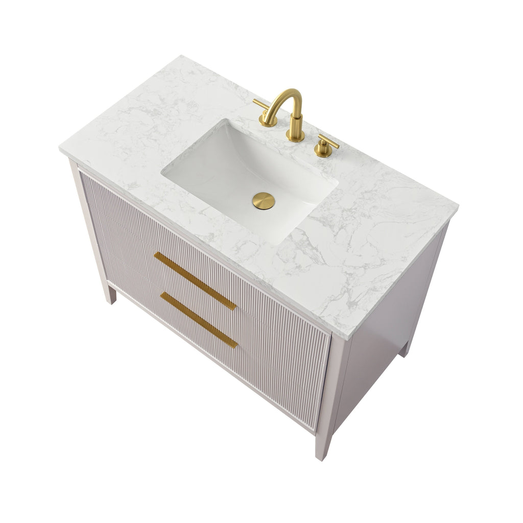 Top-down view of a freestanding single-sink bathroom vanity with a white marble-look stone countertop, rectangular undermount ceramic sink, solid wood stone-colored ribbed cabinet and brass-gold faucet and matching long drawer pulls.