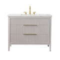 42-inch modern freestanding single-sink bathroom vanity with a stone-look marble top, undermount rectangular ceramic sink, solid wood fluted taupe cabinet with two wide drawers and long brushed brass handles and faucet.