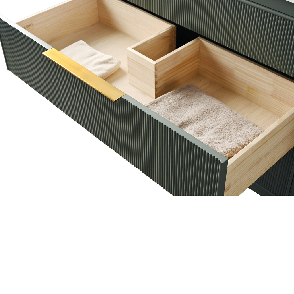 Open 42-inch single bathroom vanity drawer showing a ribbed stone-colored front with a brass-finish pull, solid wood interior dividers and neatly folded beige towels.