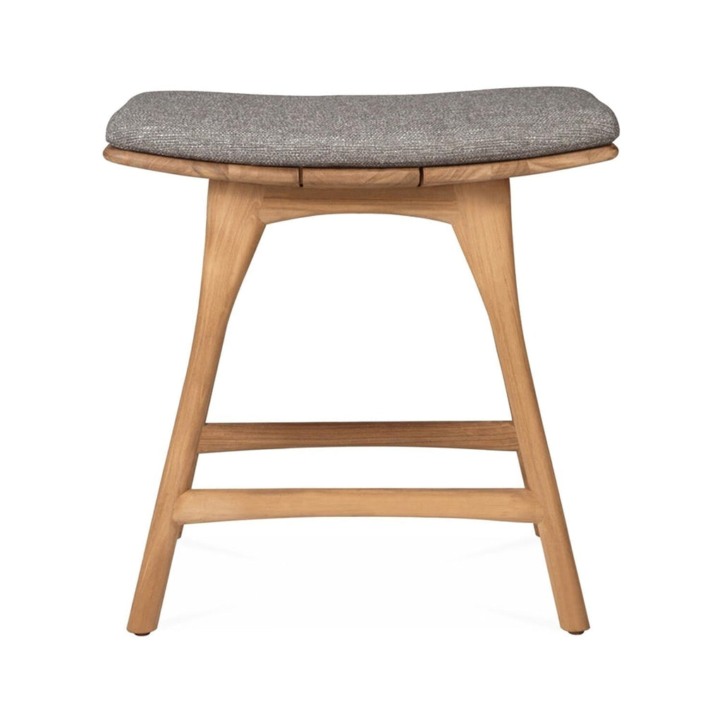 Front view of a coastal backless shower stool in natural teak with tapered legs, two horizontal stretchers and a neutral gray upholstered seat cushion.