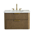 30-inch modern single-sink bathroom vanity with fluted solid wood brown cabinet, white stone countertop and integrated rectangular sink, two soft-close drawers with brass pulls and matching brass faucet.