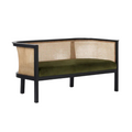 Boho-contemporary entryway bench with a black wooden frame and curved woven cane rattan back and sides, fitted with an olive green upholstered seat cushion.