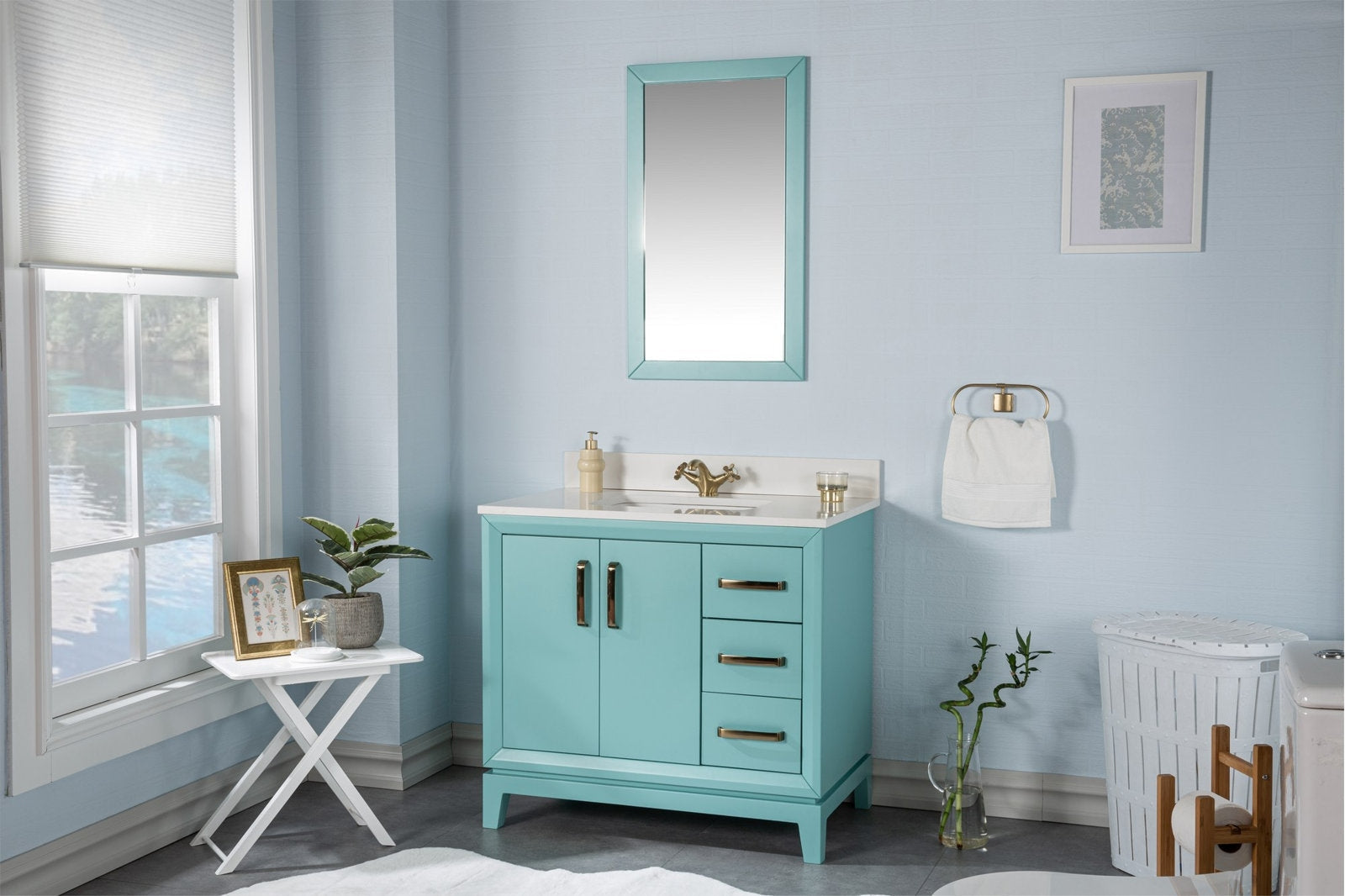 Modern turquoise solid wood bathroom vanity with a white stone top and integrated ceramic sink, brass faucet and matching brass handles, featuring three drawers and a double-door cabinet in a light-blue bathroom scene.