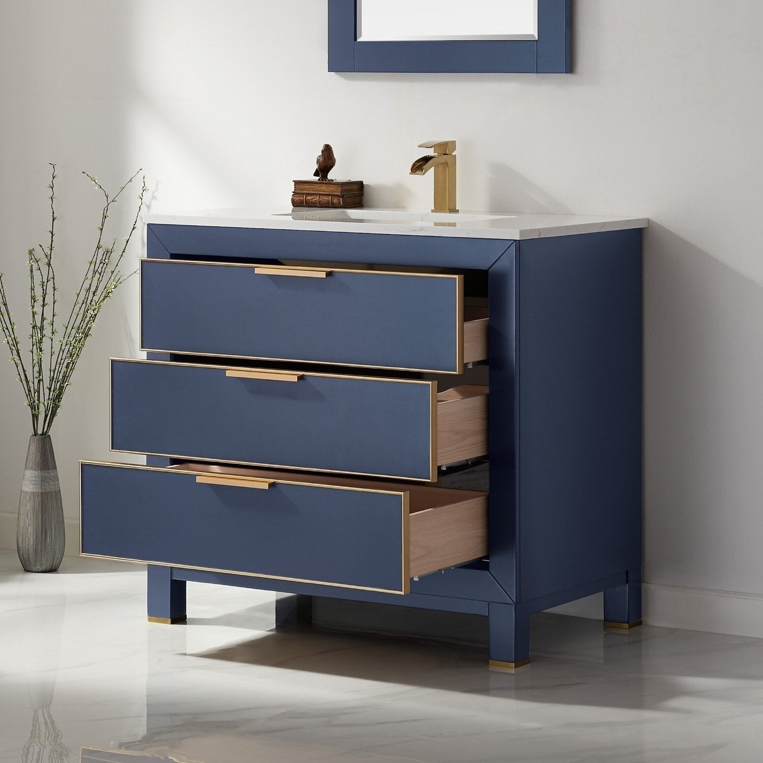 Freestanding modern 36-inch solid wood bathroom vanity with a white stone top and deep blue painted case; three soft-close drawers with gold trim and matching gold faucet, drawers partially open to show wood interiors.