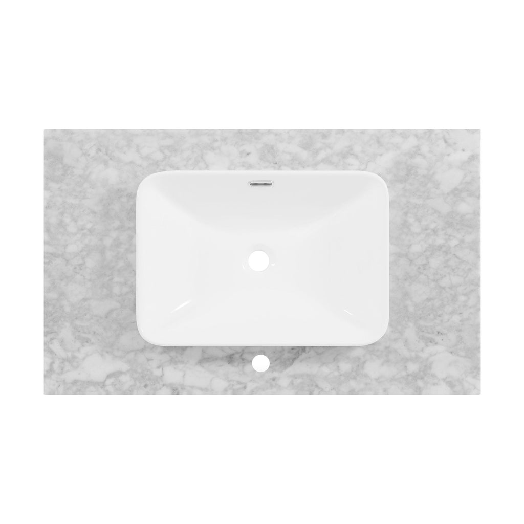 Top-down view of a white rectangular ceramic sink mounted on a light stone marble countertop, showing the centered faucet hole and integrated rear overflow slot.