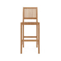 Armless teak outdoor bar stool with vertical slatted back and slatted seat in a natural finish, straight square legs and integrated footrest, coastal-contemporary solid wood design.