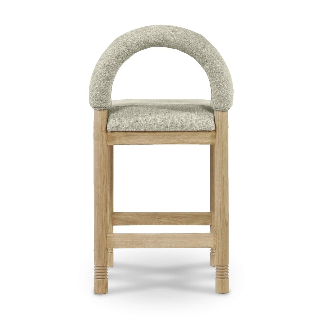 Front view of a counter stool with a rounded arched back upholstered in beige boucle fabric and a padded seat, supported by natural oak legs with a wooden footrest and subtle turned leg details.