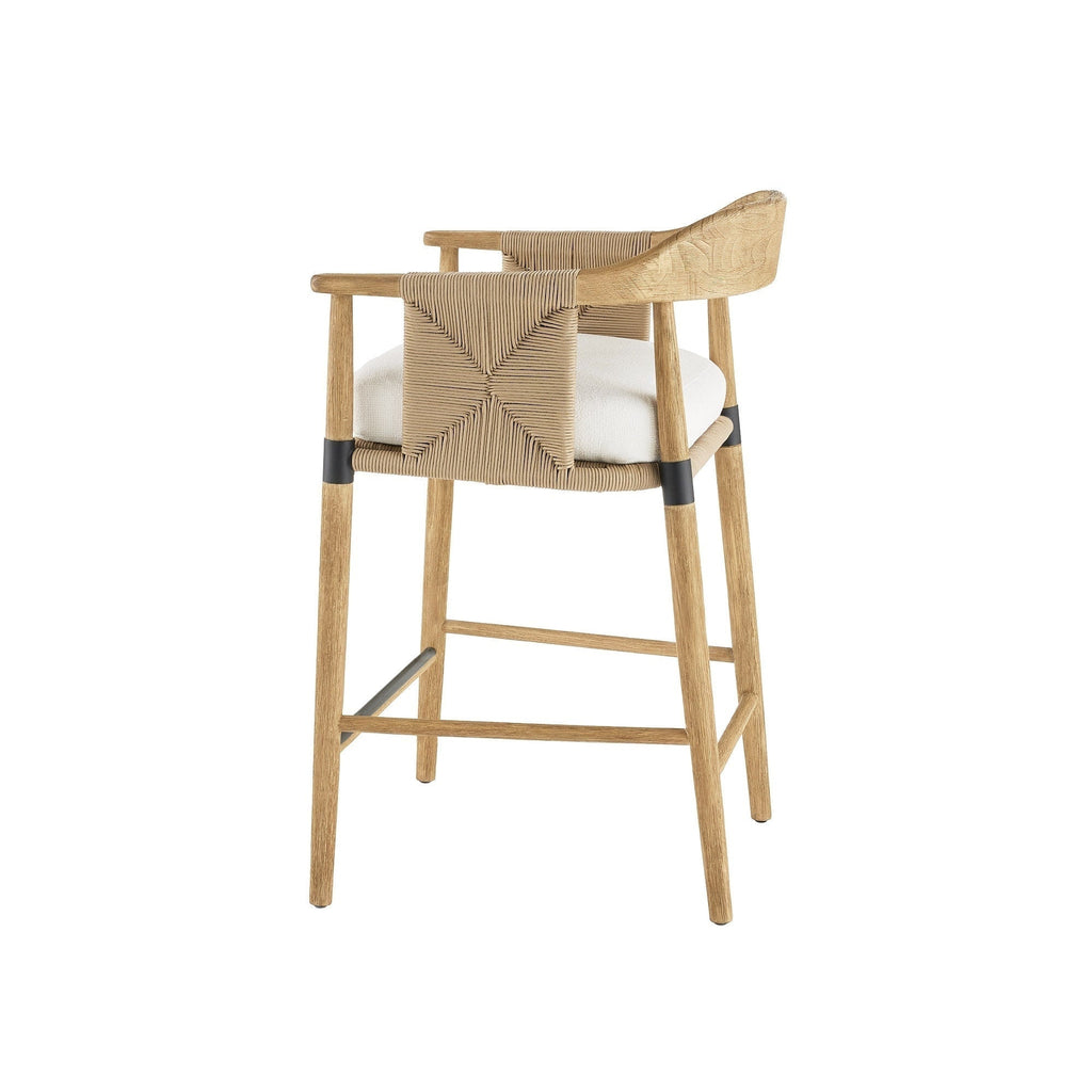 Bar-height stool in natural wood with a woven rope back, white upholstered seat cushion, curved wooden arms, and black metal leg bands and footrest.