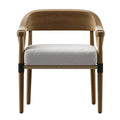 Front view of a mid-century modern oak dining chair with a curved oak back and arms, light-gray performance fabric seat cushion, woven natural rope trim along the apron and black metal collars on tapered oak legs.