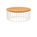 Round teak wood tabletop atop a white iron wire cage base, low rustic coffee table shown on a white background.