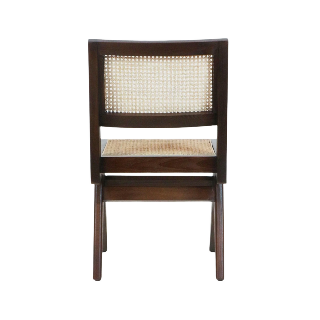 Rear view of an armless dining side chair with a walnut-stained solid wood frame and woven cane back and seat, showcasing a mid-century modern profile on a white background.