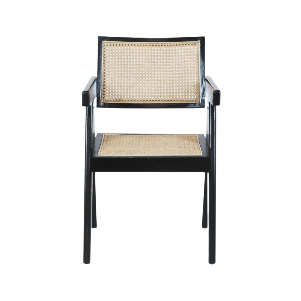 Front view of a mid-century modern dining chair with a black solid wood frame and natural cane woven seat and back, straight armrests and slender tapered legs.