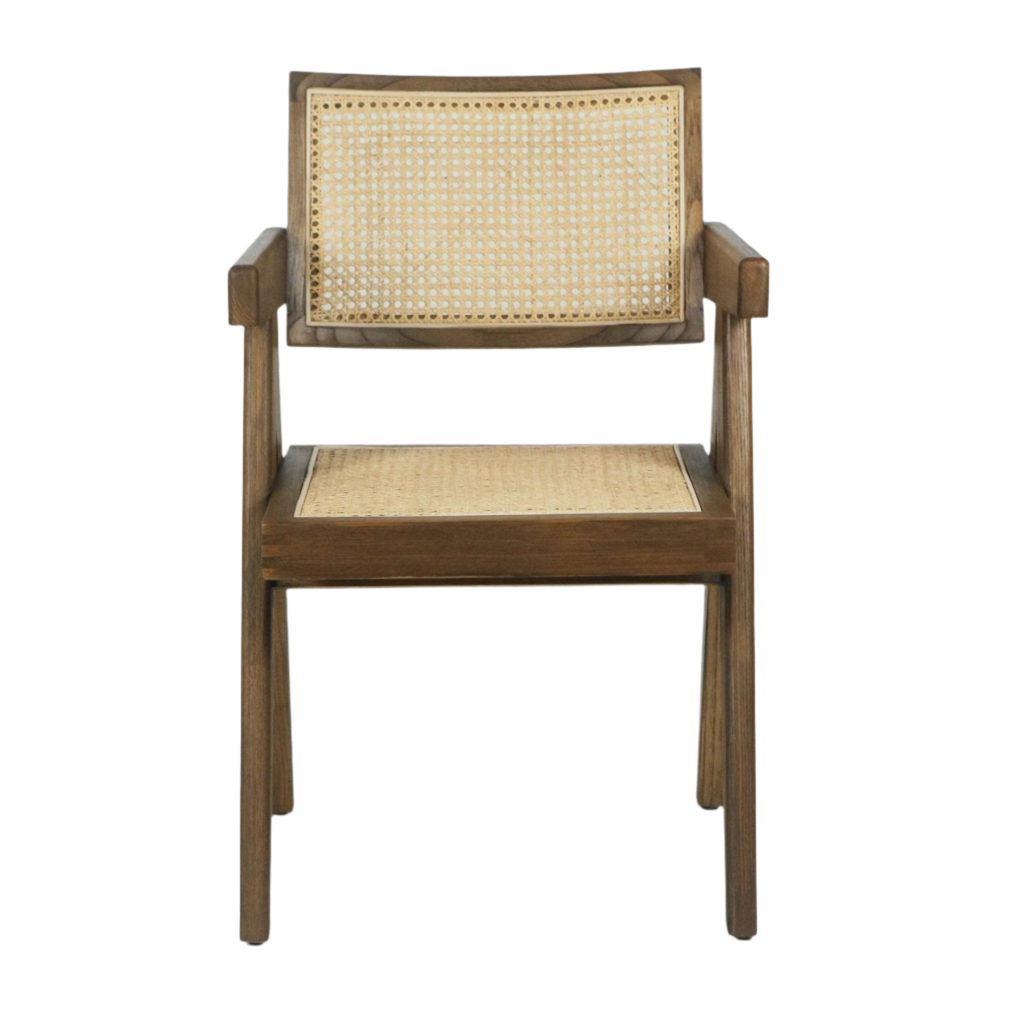 Front view of a mid-century modern teak dining chair with a medium-brown solid wood frame, natural cane-woven back and seat, and squared arms on a white background.