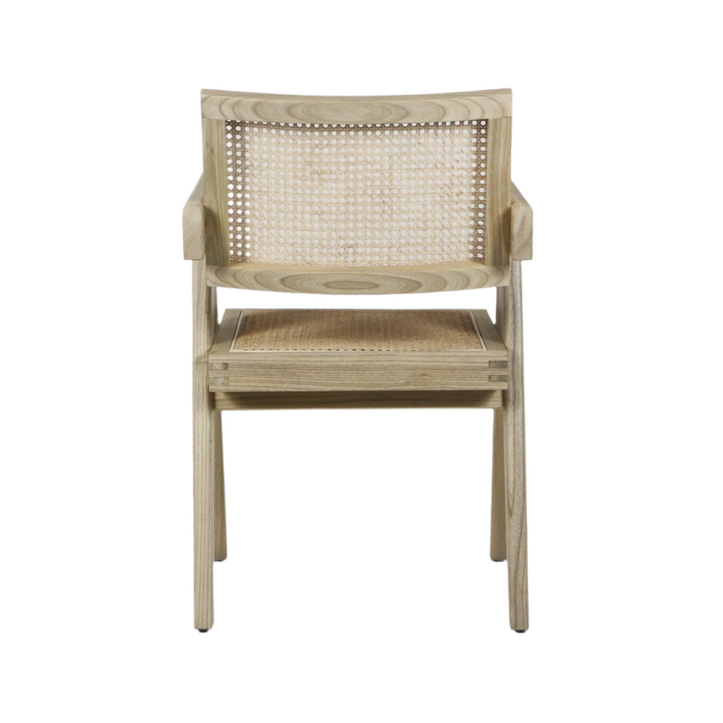 Front view of a mid-century modern dining chair with a natural wood frame, woven cane back and seat, short armrests and tapered legs on a white background.