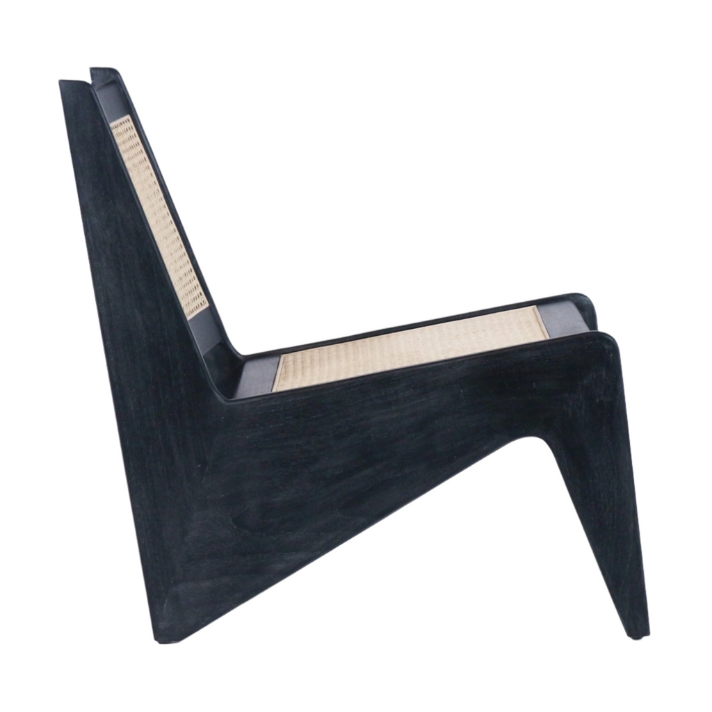 Side view of a low-profile mid-century modern lounge chair with black-stained solid teak frame and natural woven cane seat and back, featuring an angular armless silhouette and low wooden legs.