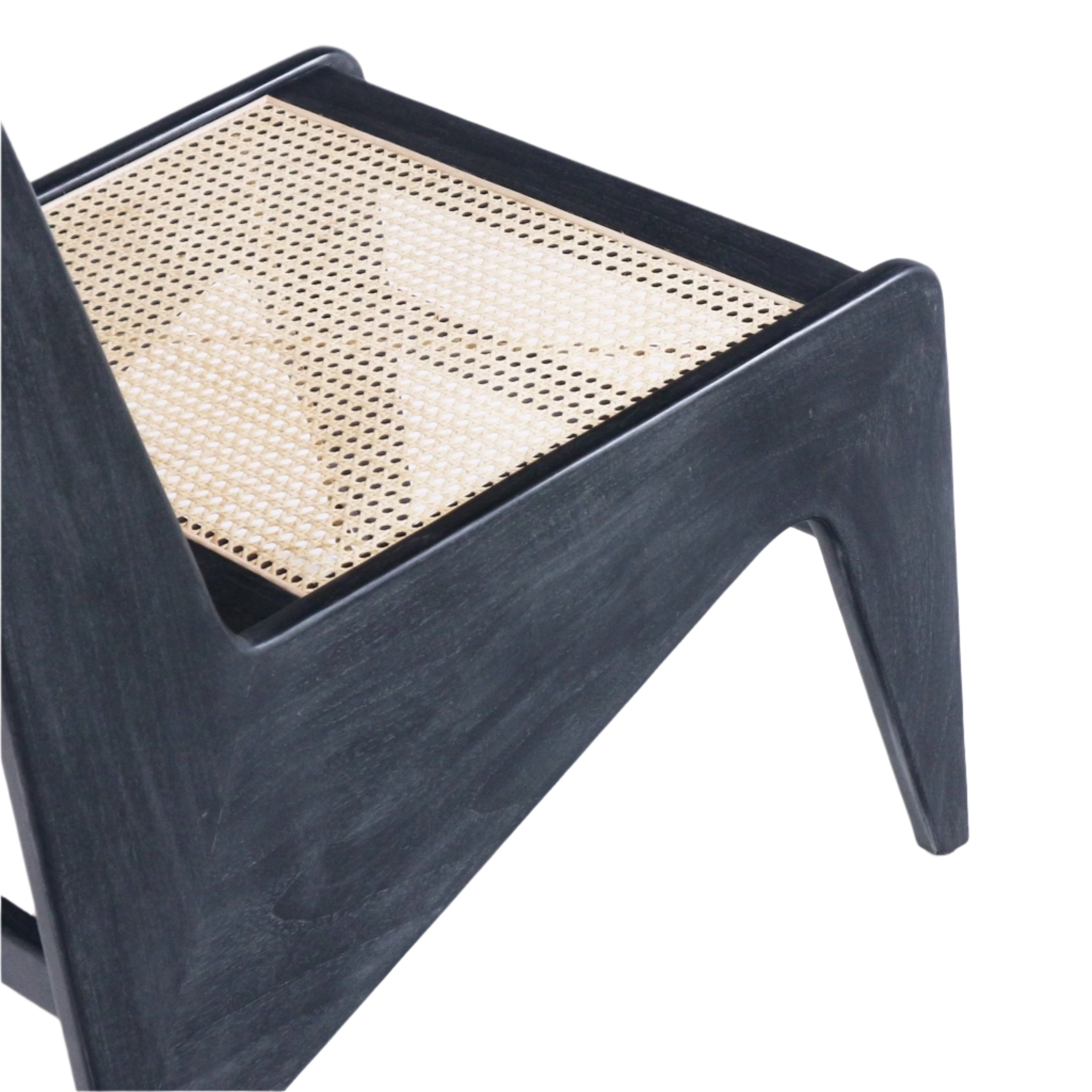 Close-up of a smoked black solid-wood chair frame with a natural woven cane seat, highlighting the angled leg and triangular side cutout in a mid-century modern silhouette.