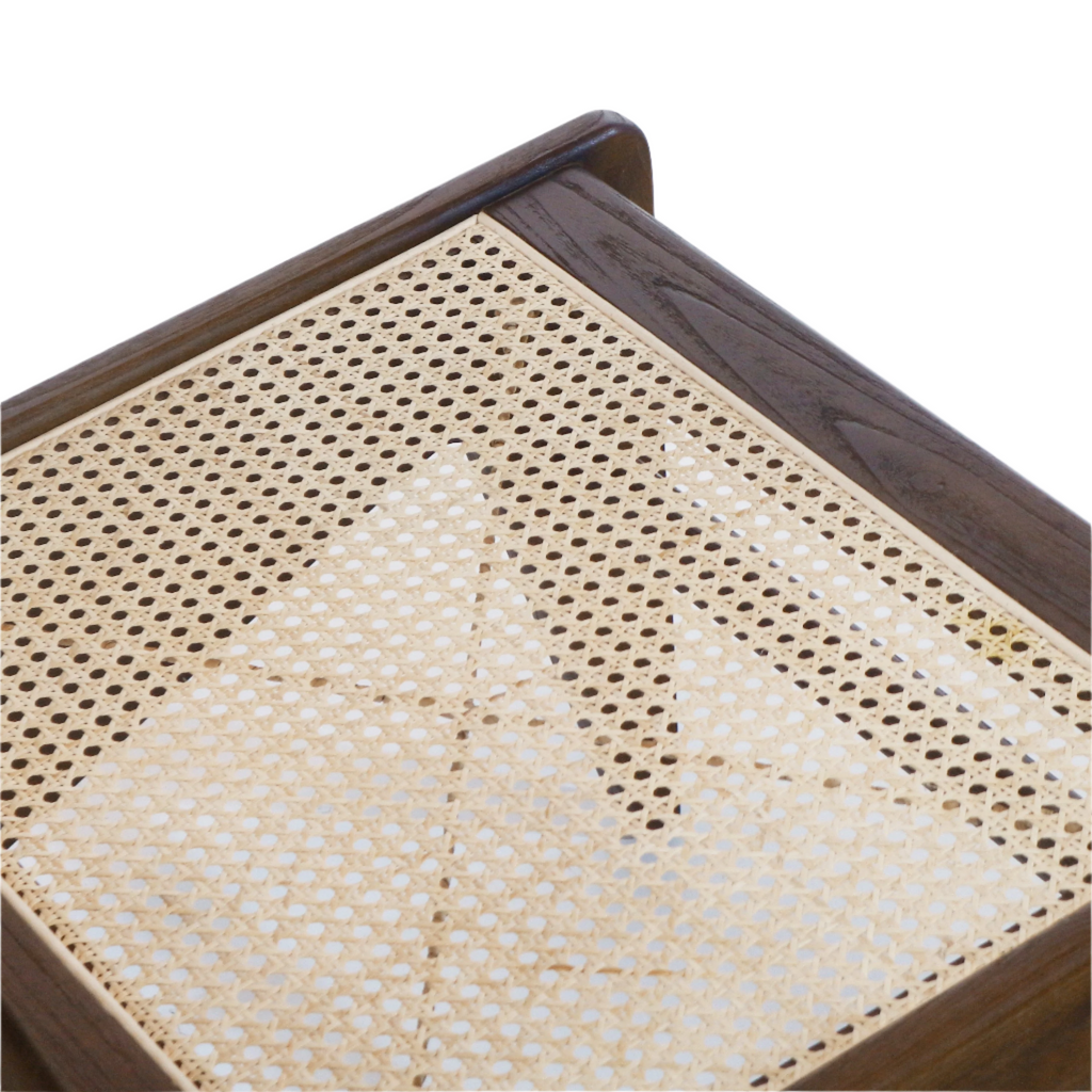 Close-up of a natural beige woven cane seat inset in a dark teak solid wood frame, highlighting the hexagonal cane pattern and visible corner joinery.