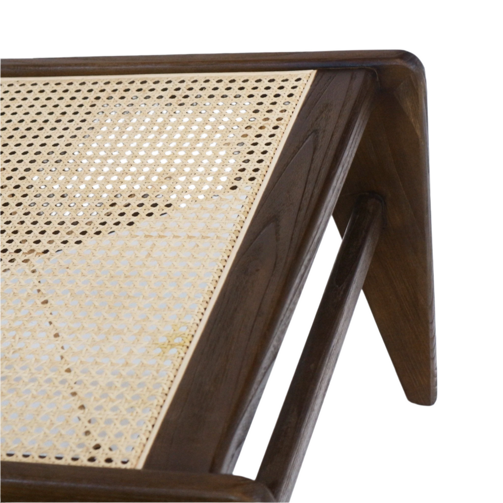 Close-up of a beige woven cane seat set into a warm teak solid-wood frame, showing the angled mid-century modern leg and rounded dowel support.