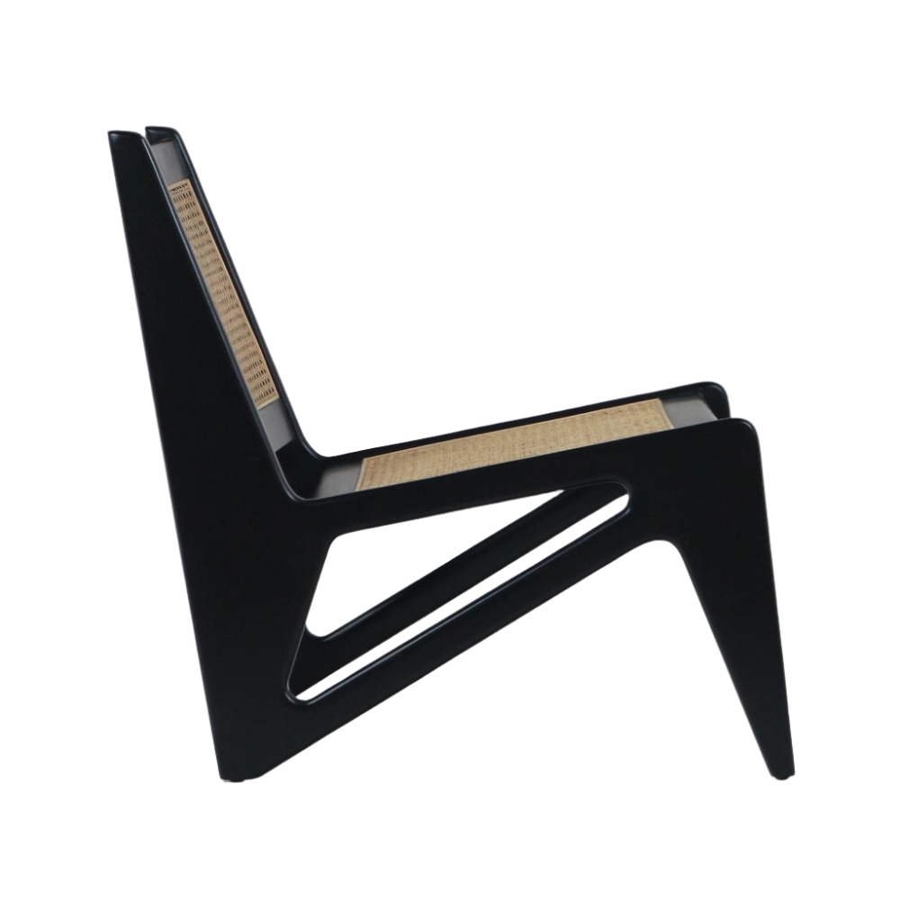Low modern lounge chair with a black solid-wood frame and natural woven cane seat and back, armless kangaroo-style profile with angled legs and triangular cutouts in the side panels.