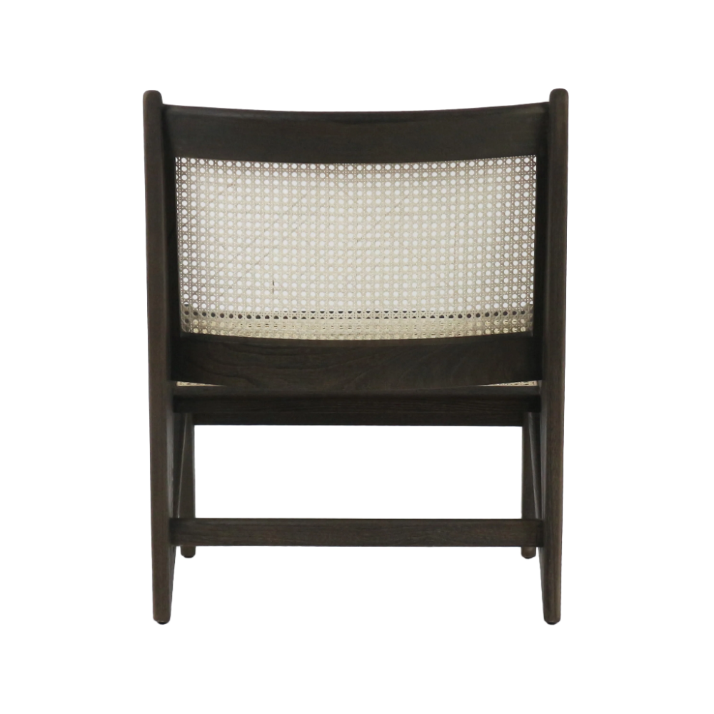 Rear view of a modern low lounge chair in dark teak solid wood with a natural woven cane back panel and tapered legs on a white background.