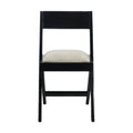 Front view of an armless side chair with a black wood frame and beige upholstered seat cushion, low straight back and tapered legs in a mid-century modern style on a white background.