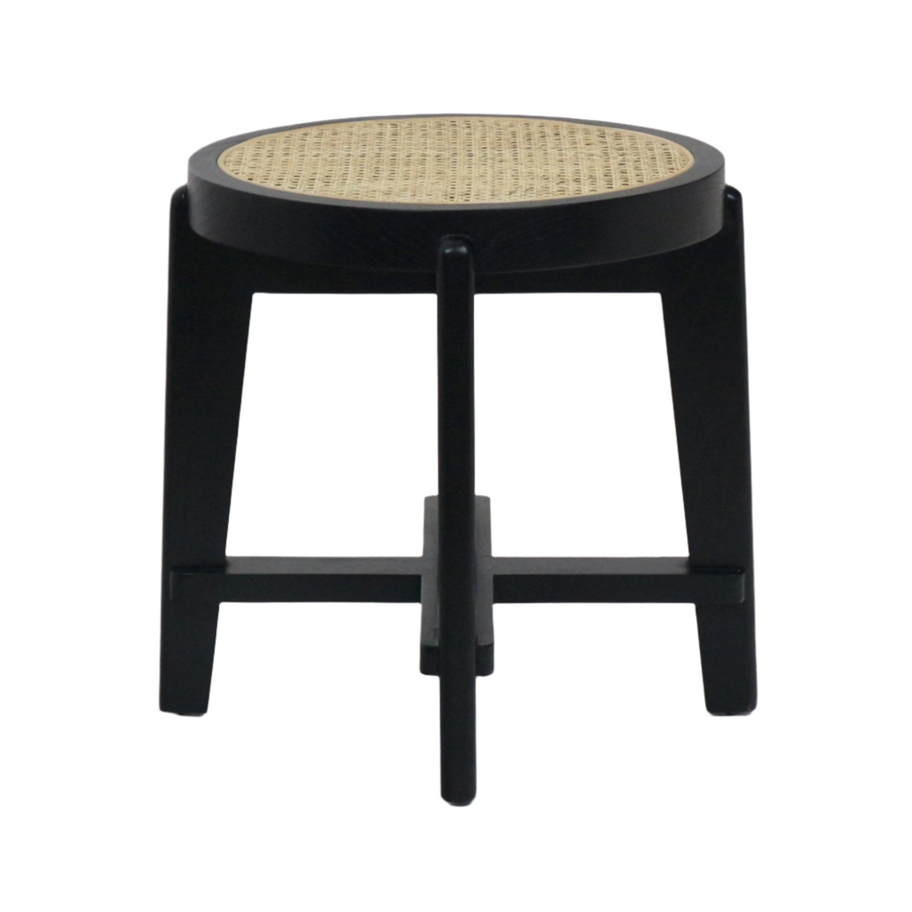 Backless round stool with a natural woven cane seat set into a black solid wood frame, four tapered legs and a cross stretcher detail, modern mid-century style suitable as a side table or accent stool.