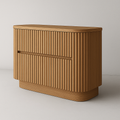 Natural oak fluted two-drawer dresser with rounded corners and recessed horizontal pull, featuring vertical ribbed detailing and a low modern profile with warm wood grain finish.
