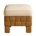Front view of a small square footstool with a cream boucle cushion resting on a warm natural woven rattan base featuring thick rope-wrapped legs in a checkerboard weave.