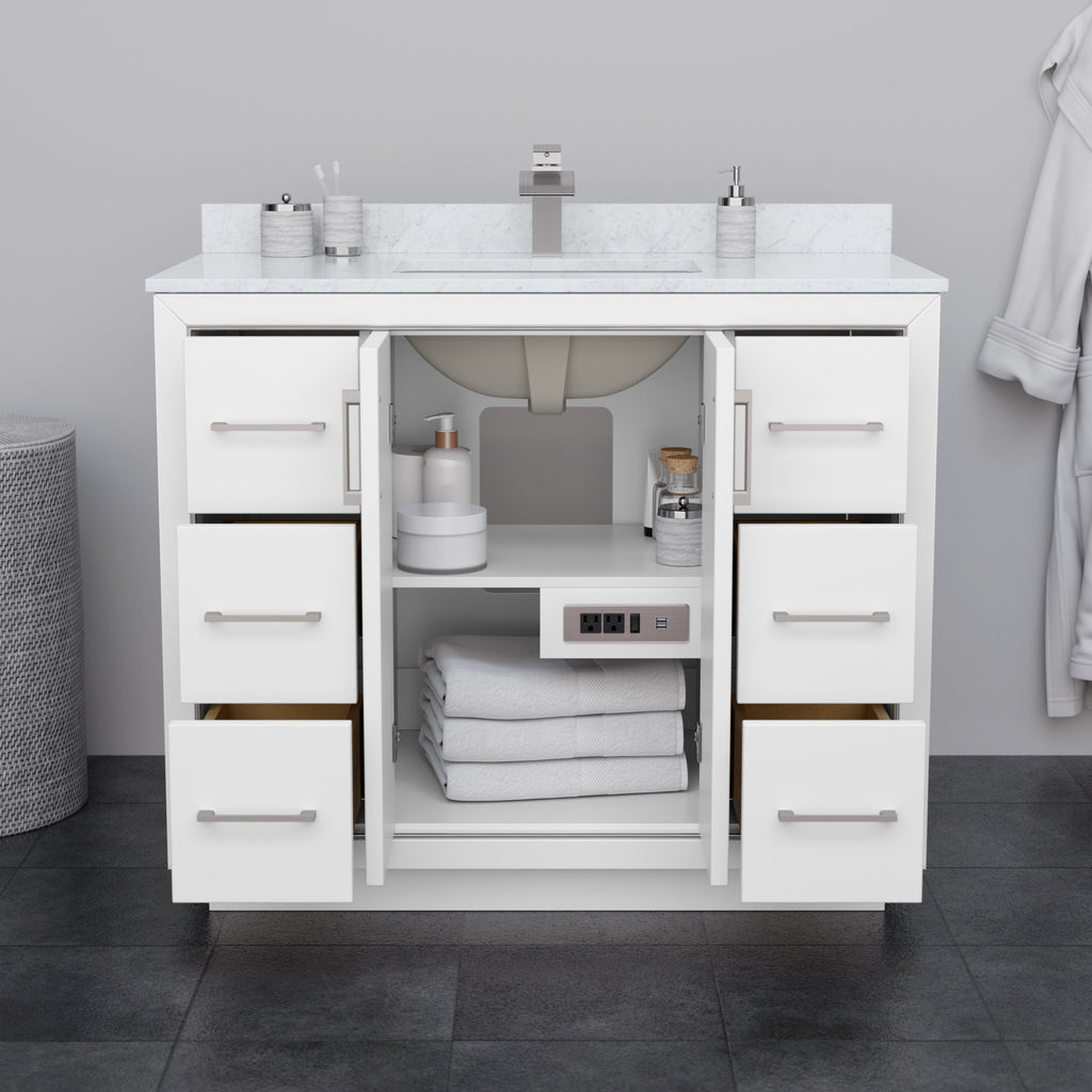 Front view of a 42-inch modern white solid wood bathroom vanity with a stone top and single integrated sink, six drawers flanking an open center cabinet with folded towels and a built-in outlet, brushed-nickel handles.