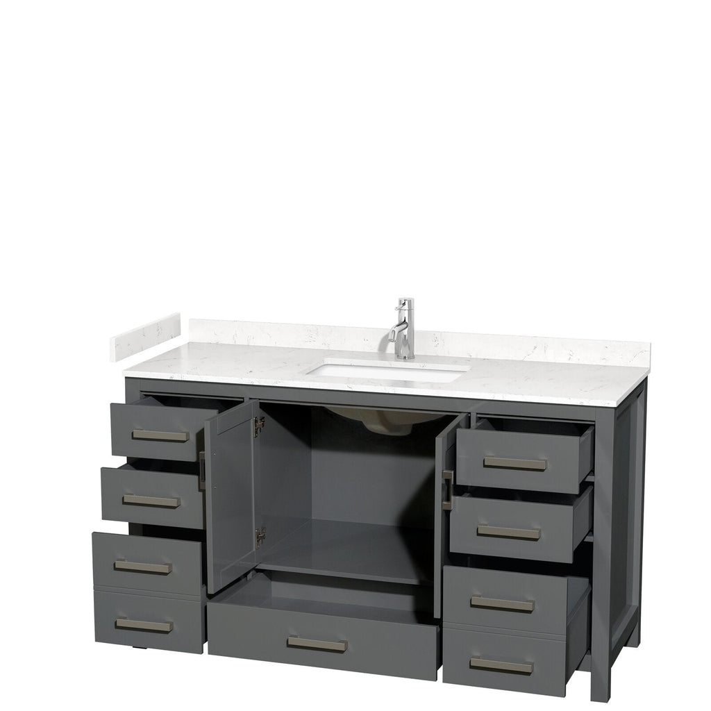 Freestanding modern gray wood bathroom vanity with white stone countertop and integrated single sink, chrome faucet, open center cabinet showing plumbing and shelf, and multiple drawers with brushed metal handles.