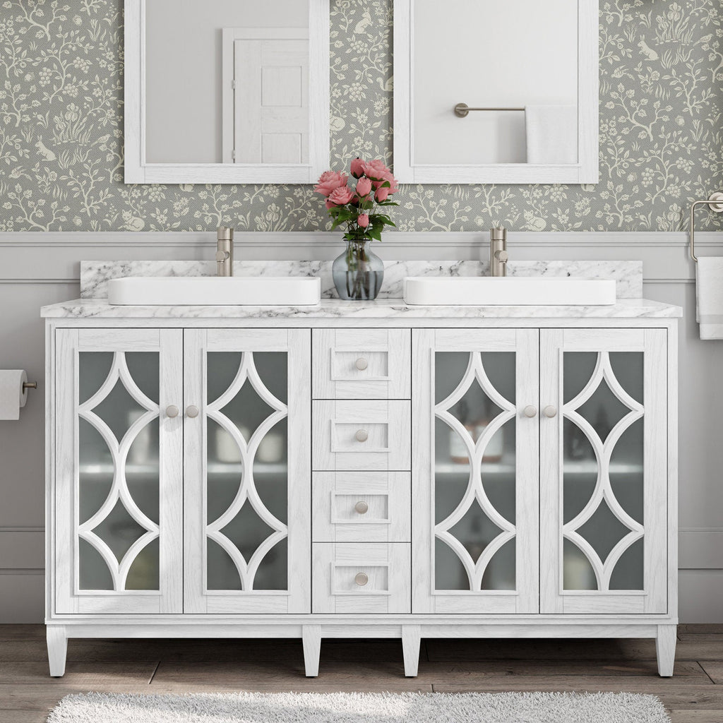Stone-top white solid-wood 60-inch double-sink bathroom vanity with marble-look countertop, two rectangular white vessel sinks, brushed-nickel faucets, decorative frosted-glass cabinet doors, center drawers and a vase of pink flowers.