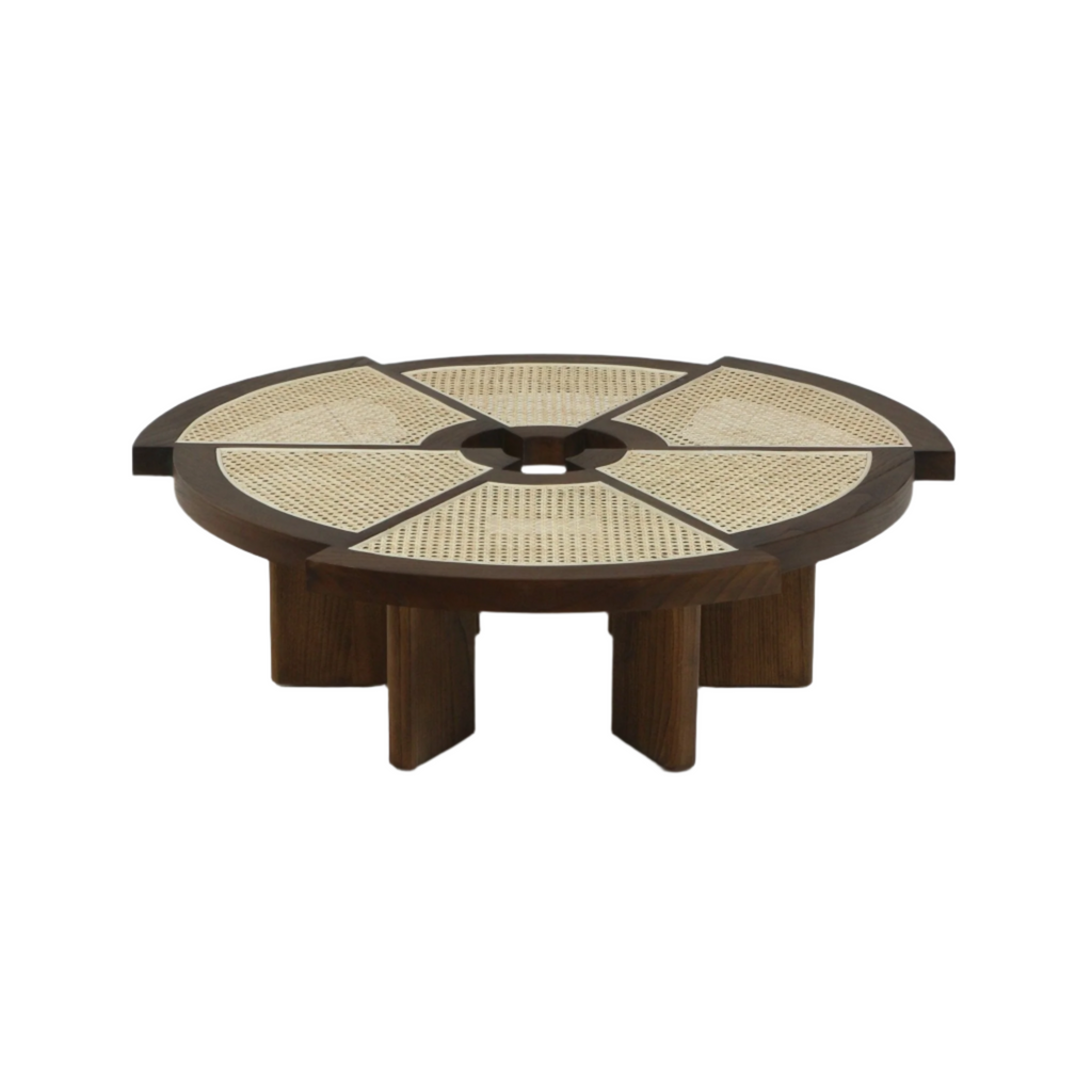Low round coffee table with a dark wood frame and six natural cane inlay panels radiating from a central opening, supported by chunky wooden legs for a modern midcentury look.