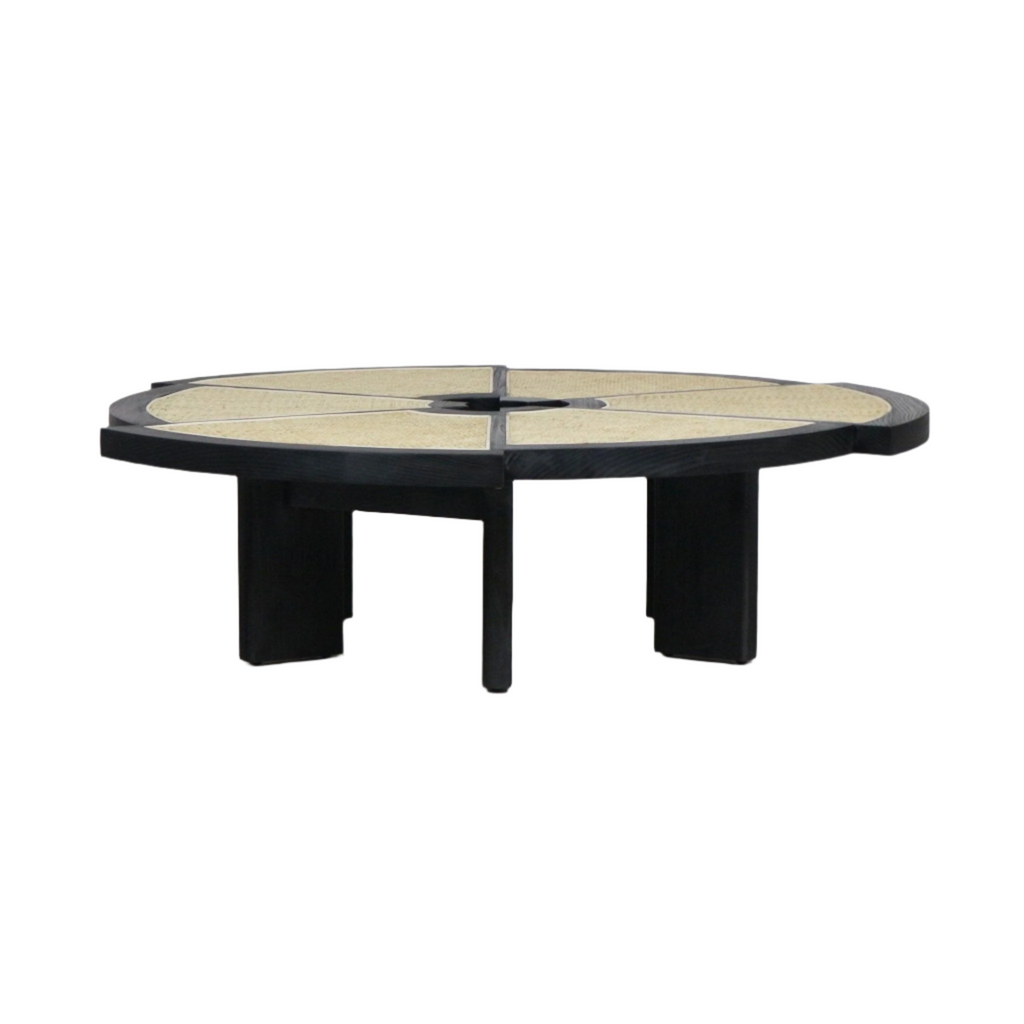 Low round coffee table with a black-stained wood frame and segmented natural cane top divided into wedge panels around a small center opening, supported by chunky black wooden legs for a modern midcentury look.