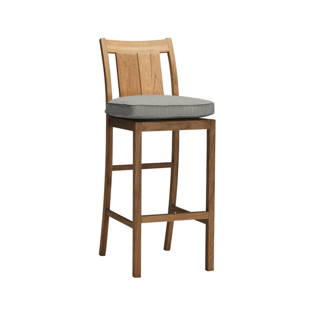Armless teak outdoor bar stool in a natural finish featuring a curved slatted back, tall square legs and a gray pinstripe removable seat cushion, designed for coastal kitchen or patio counter seating.