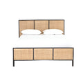 Front view of a teak and rattan boho-style platform bed with a dark wooden frame, three-panel woven rattan headboard and matching footboard, shown with white bedding and two pillows.