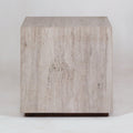 Front view of a modern cube-shaped nightstand made from natural beige travertine with subtle vertical veining, sitting on a slim wood base.