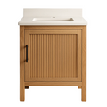 Front view of a 24-inch freestanding single-sink bathroom vanity in natural solid wood with a vertical ribbed cabinet door, matte black bar handle, and a stone-colored countertop with integrated rectangular sink and backsplash.