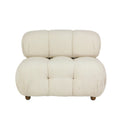 Cream boucle upholstered sofa with rounded tufted seat and back, low-profile armless silhouette and short wooden legs for a modern living room.