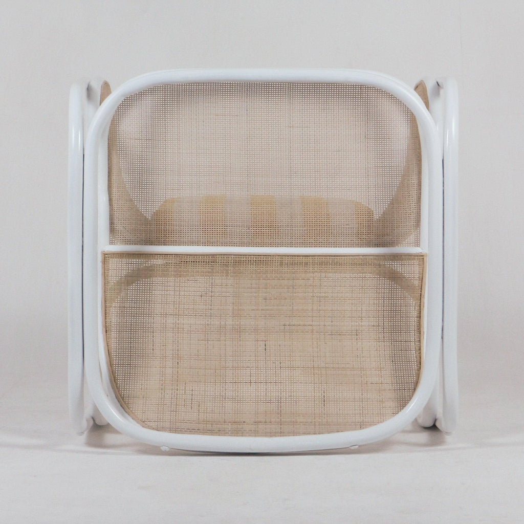 Front view of a modern white metal-framed lounge chair with natural cane back and seat and a beige striped seat cushion.
