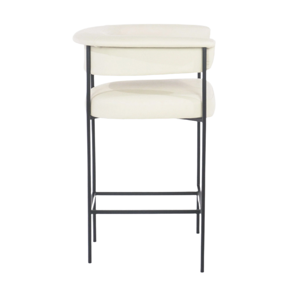 Front view of a modern cream faux leather counter stool with a curved low back, padded seat and slender black metal frame with integrated footrest, shown on a white background.