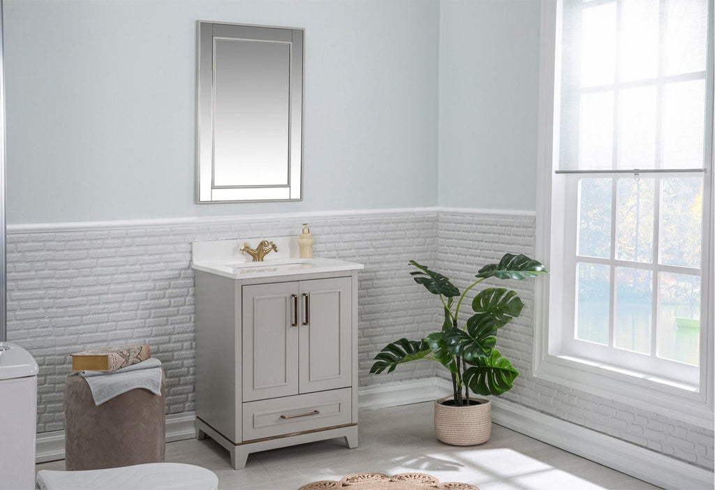 Modern solid wood single-sink bathroom vanity in a stone finish with a stone top and ceramic sink, paired with a gold faucet and mirror, shown freestanding in a light bathroom beside a potted plant and sunlit window.