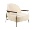 Cream boucle upholstered accent chair with rounded back, low-profile seat, dark wooden armrests and slender brass-finish metal legs in a modern minimalist silhouette.